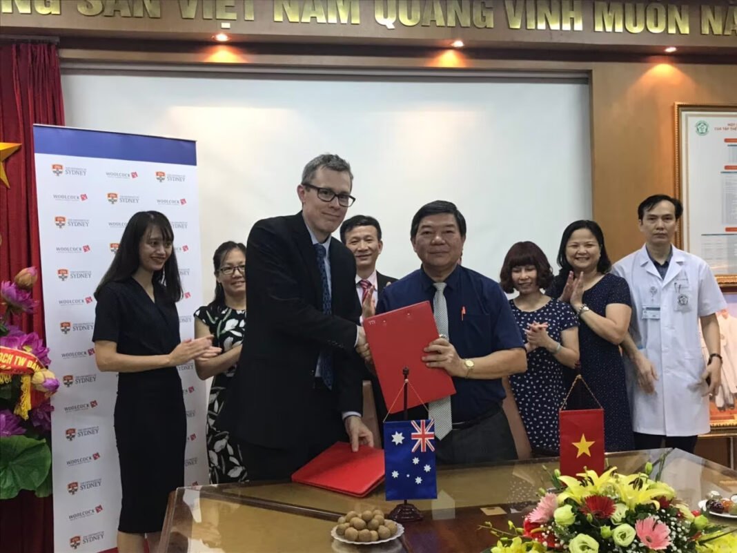 Professor Greg Fox (front left) at the Memorandum of Understanding signing with Bach Mai Hospital in Vietnam.